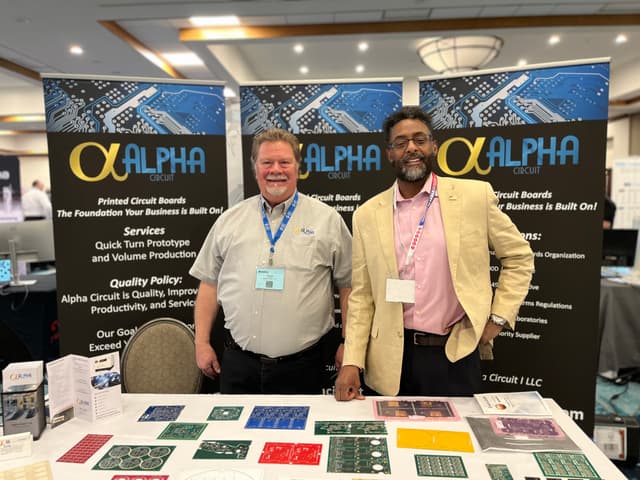Alpha Circuit team members at trade show booth
