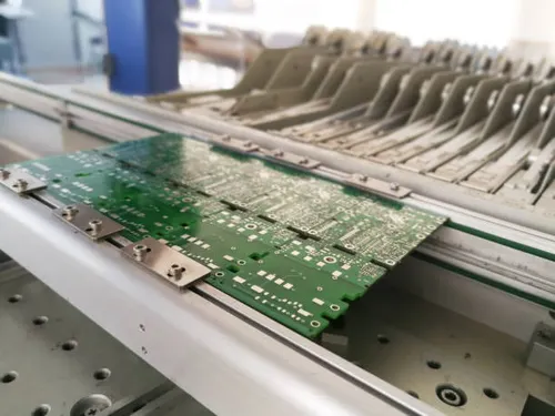 Pcb assembly first stages. Pcb on the rails of production line inside pick and place machine.